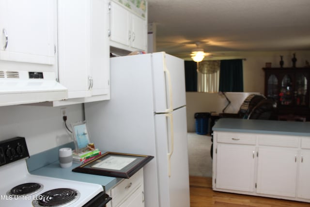 kitchen featuring white cabinets, light hardwood / wood-style flooring, white appliances, and extractor fan