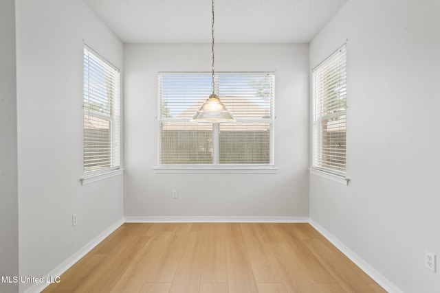 1593 Rachel Dr, Biloxi, MS 39532 - unfurnished dining area featuring light wood-type flooring and a textured ceiling