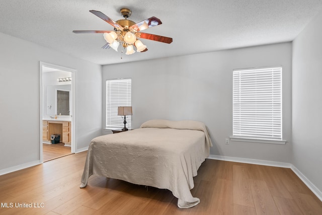 1593 Rachel Dr, Biloxi, MS 39532 - bedroom featuring light wood-type flooring, a ceiling fan, and ensuite bathroom