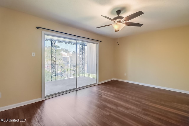 unfurnished room featuring dark wood finished floors, a ceiling fan, and baseboards