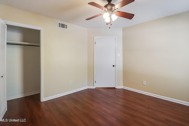 unfurnished bedroom with ceiling fan, wood finished floors, visible vents, and baseboards