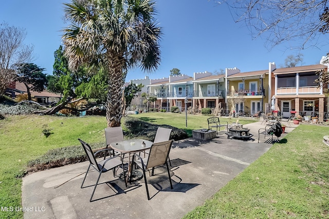 view of patio featuring a residential view, a balcony, and an outdoor fire pit
