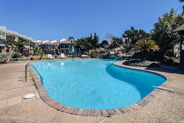 pool featuring a residential view and fence