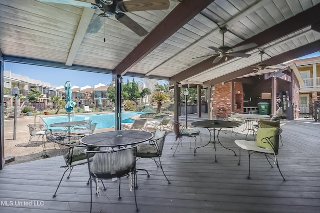 deck with a ceiling fan and a community pool