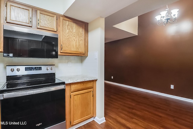 kitchen featuring electric range, baseboards, dark wood-style flooring, and backsplash
