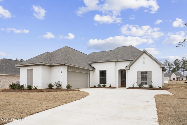 french provincial home with a garage