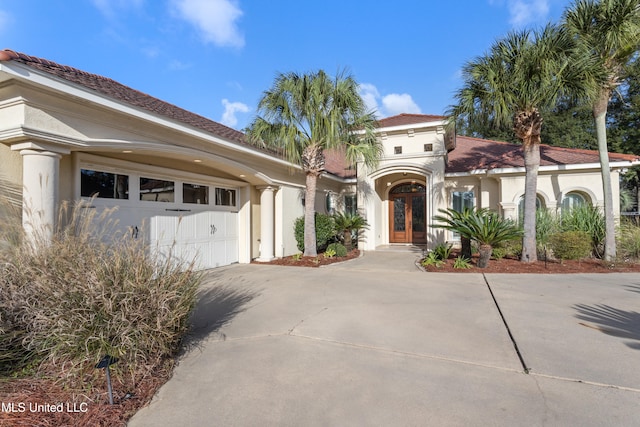 mediterranean / spanish-style house with a garage