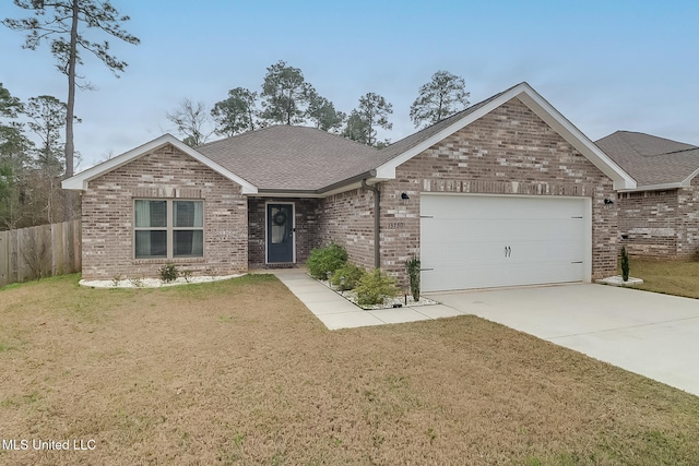 view of front of home featuring a garage and a front yard