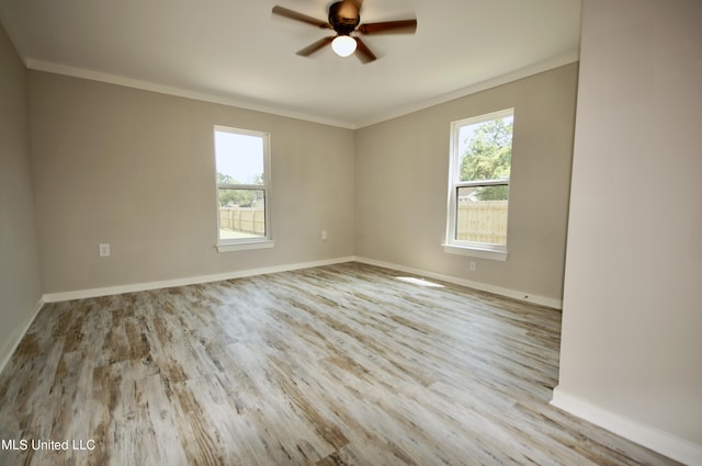 2200 19th Ave, Gulfport, MS 39501 - unfurnished room with healthy amount of natural light, crown molding, wood finished floors, a ceiling fan, and baseboards