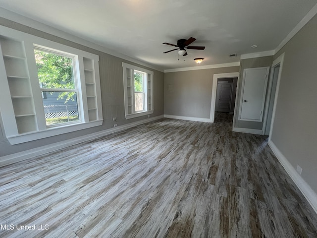 2200 19th Ave, Gulfport, MS 39501 - spare room with wood finished floors, crown molding, baseboards, ceiling fan, and built in shelves