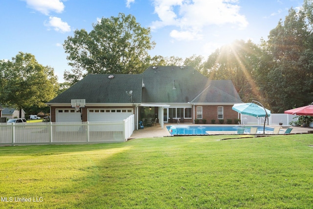 4424 Rebekah Dr, Olive Branch, MS 38654 - back of house with an attached garage, an outdoor pool, and brick siding