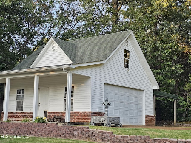 4424 Rebekah Dr, Olive Branch, MS 38654 - view of front facade featuring brick siding, covered porch, a shingled roof, and a detached garage