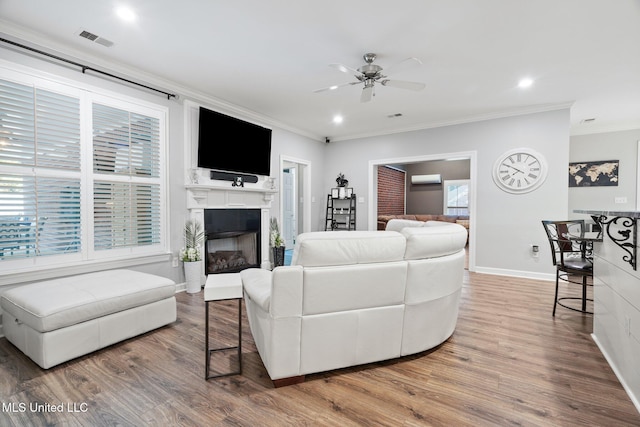 4424 Rebekah Dr, Olive Branch, MS 38654 - living area with crown molding, a ceiling fan, wood finished floors, baseboards, and a fireplace