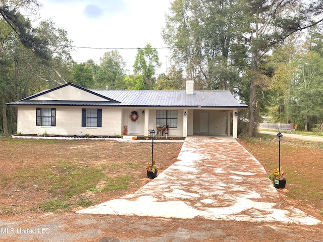 ranch-style house with a front lawn and a carport