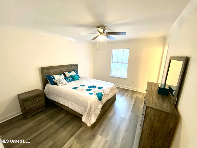 bedroom with ceiling fan, dark hardwood / wood-style flooring, and ornamental molding