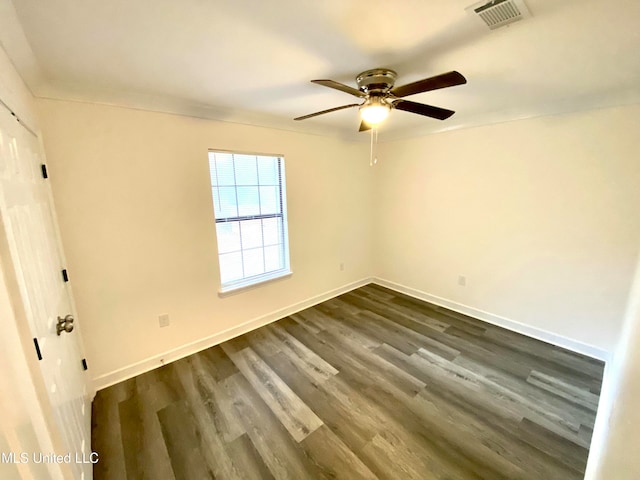 empty room featuring ceiling fan and dark hardwood / wood-style flooring