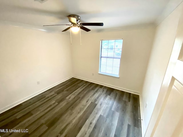 spare room featuring dark hardwood / wood-style floors and ceiling fan