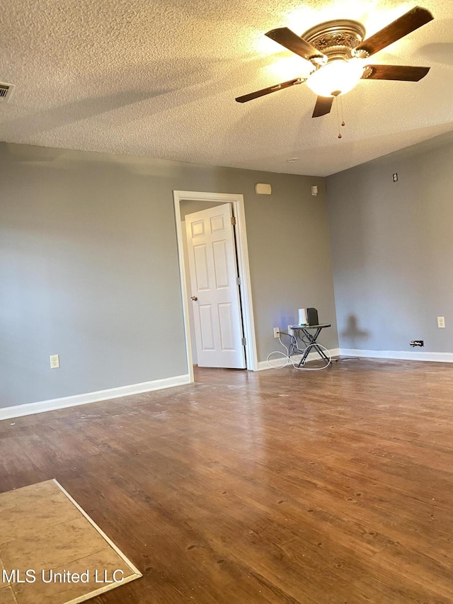 empty room with hardwood / wood-style floors, a textured ceiling, and ceiling fan