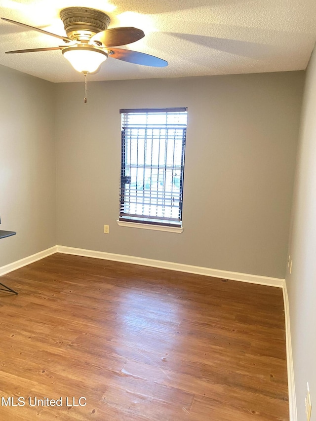 unfurnished room featuring ceiling fan, hardwood / wood-style floors, and a textured ceiling