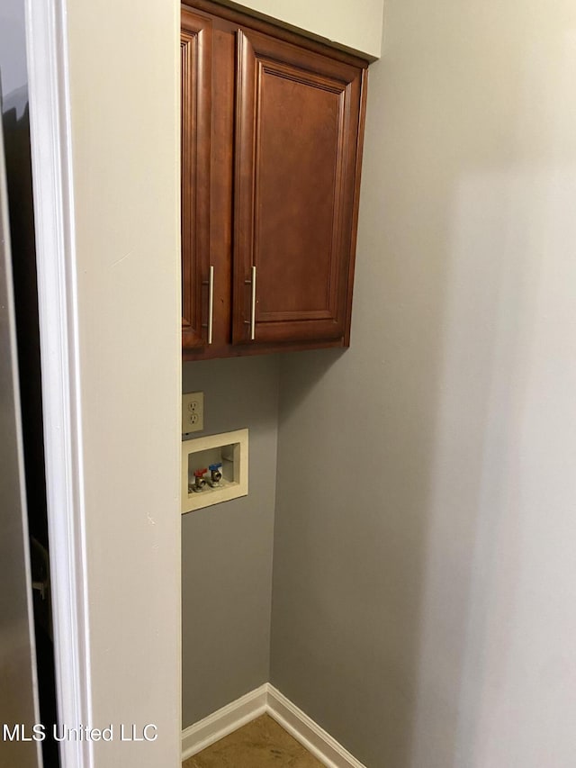 clothes washing area with hookup for a washing machine and cabinets