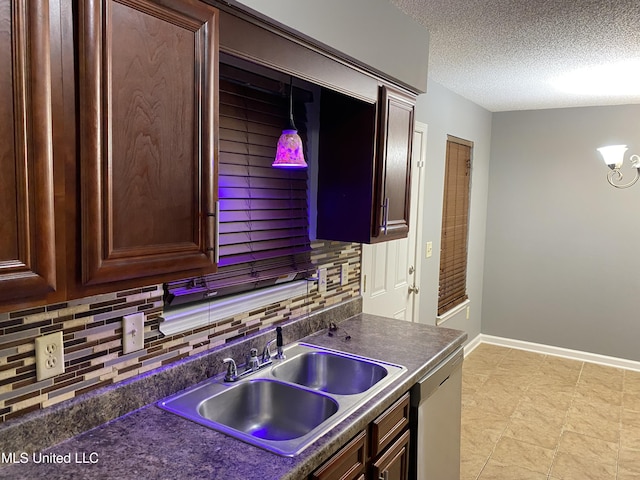 kitchen featuring dark brown cabinetry, sink, tasteful backsplash, a textured ceiling, and dishwasher