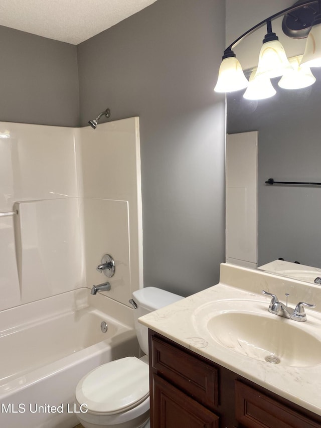 full bathroom featuring vanity, toilet, tub / shower combination, and a textured ceiling