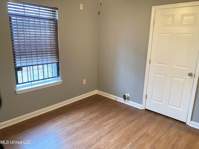 unfurnished room featuring hardwood / wood-style floors