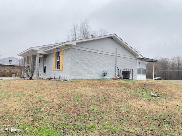 view of side of property with a lawn