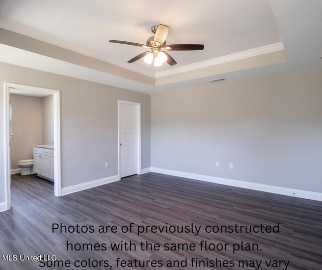 unfurnished bedroom featuring ornamental molding, dark hardwood / wood-style floors, and a raised ceiling