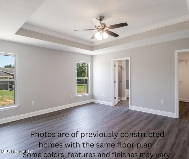 unfurnished room with dark hardwood / wood-style floors, a healthy amount of sunlight, and ceiling fan