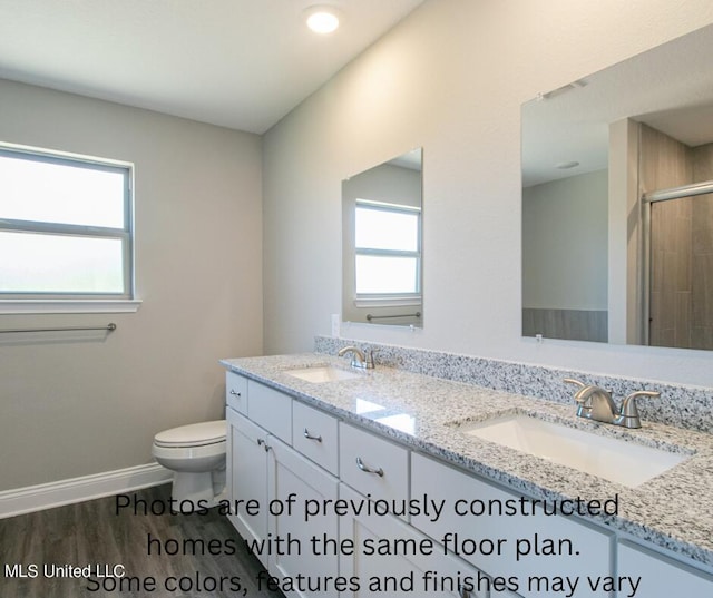 bathroom featuring vanity, toilet, a wealth of natural light, and hardwood / wood-style floors