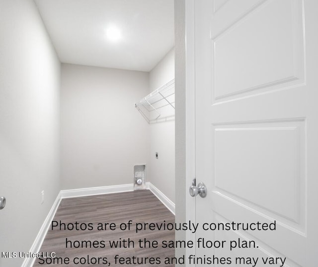 laundry area featuring dark wood-type flooring and hookup for an electric dryer