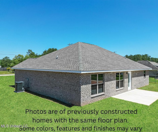 rear view of house featuring a patio area, central AC, and a lawn