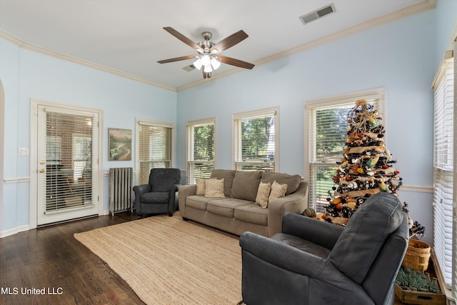 living room with ornamental molding, radiator, dark wood-type flooring, and ceiling fan