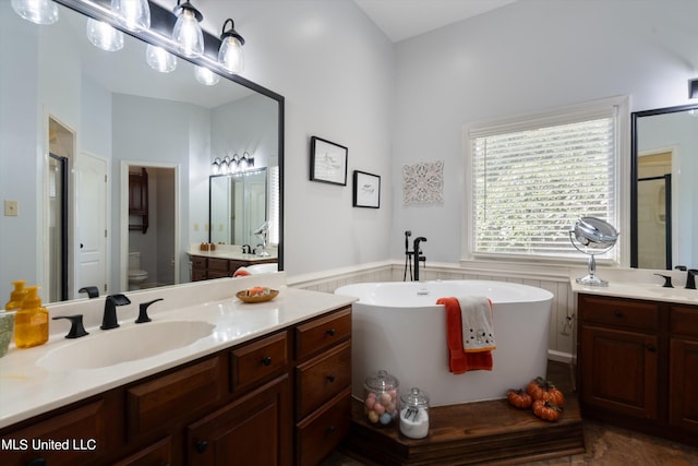 full bathroom featuring vanity, shower with separate bathtub, and toilet