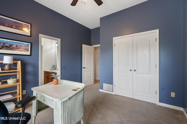 home office with dark carpet and ceiling fan