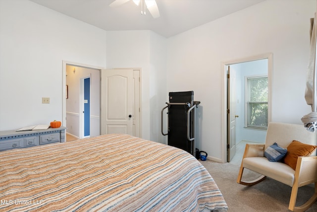 carpeted bedroom featuring a closet, ceiling fan, and ensuite bathroom