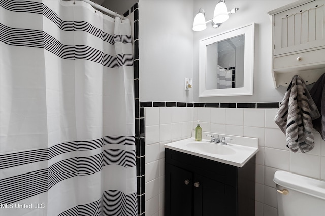 bathroom featuring vanity, toilet, tile walls, and a shower with shower curtain