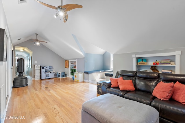 living room with lofted ceiling, light hardwood / wood-style flooring, and ceiling fan