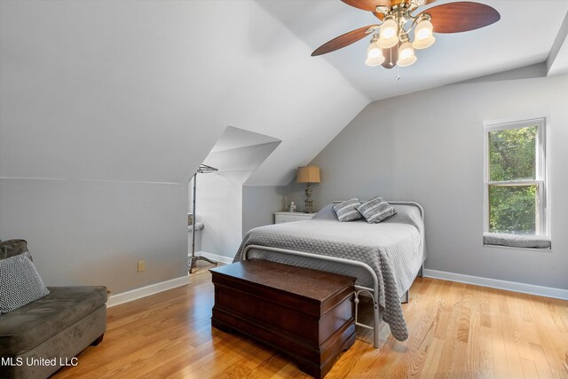 bedroom featuring ceiling fan, lofted ceiling, and light hardwood / wood-style flooring