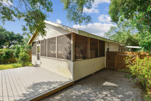 view of side of home featuring a deck and a sunroom