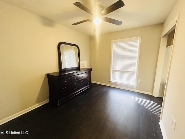 unfurnished bedroom with dark hardwood / wood-style floors and ceiling fan