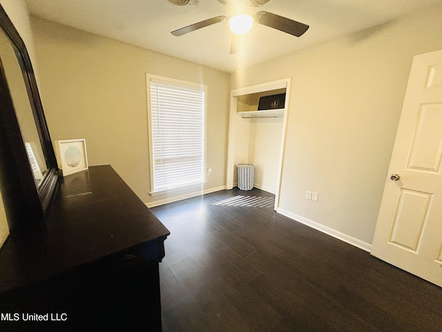 bedroom featuring dark hardwood / wood-style floors, ceiling fan, and a closet