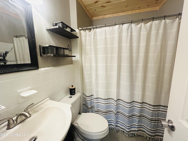 bathroom featuring toilet, wooden ceiling, sink, and tasteful backsplash