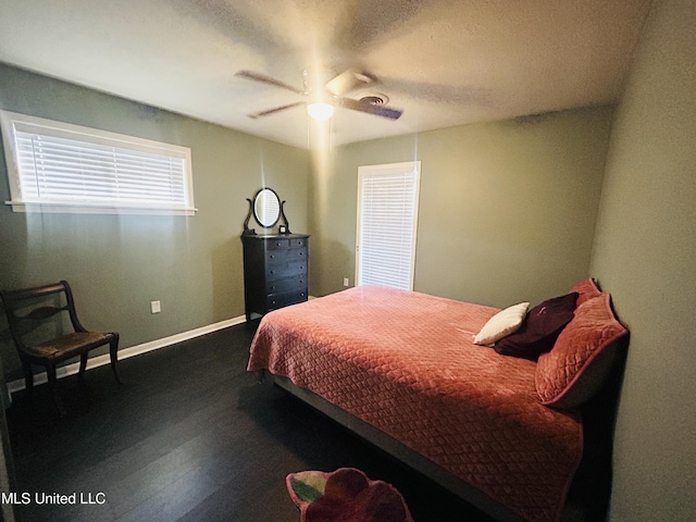 bedroom with dark hardwood / wood-style floors and ceiling fan