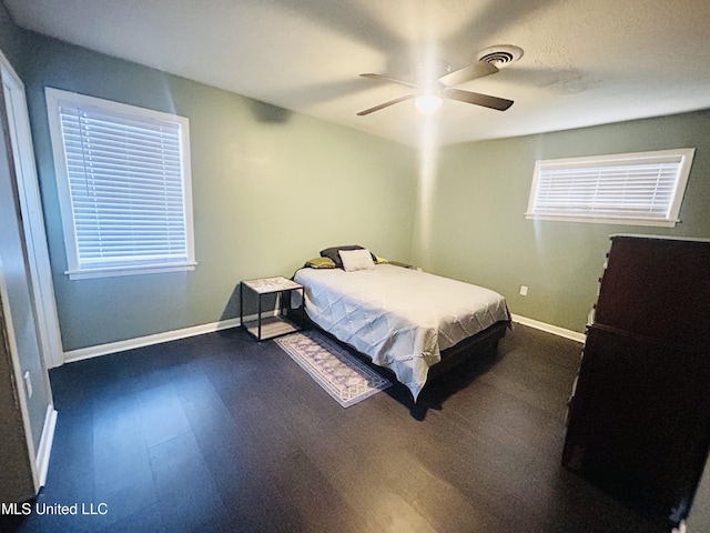 bedroom featuring ceiling fan and dark hardwood / wood-style flooring