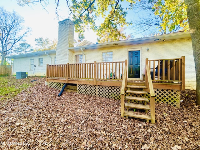 back of house featuring cooling unit and a wooden deck