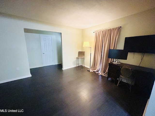 interior space with dark hardwood / wood-style flooring and a textured ceiling