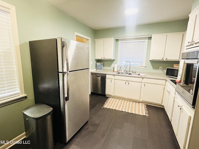 kitchen featuring dark wood-type flooring, white cabinetry, sink, and stainless steel appliances