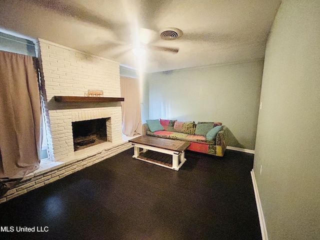 living room with a fireplace and a textured ceiling